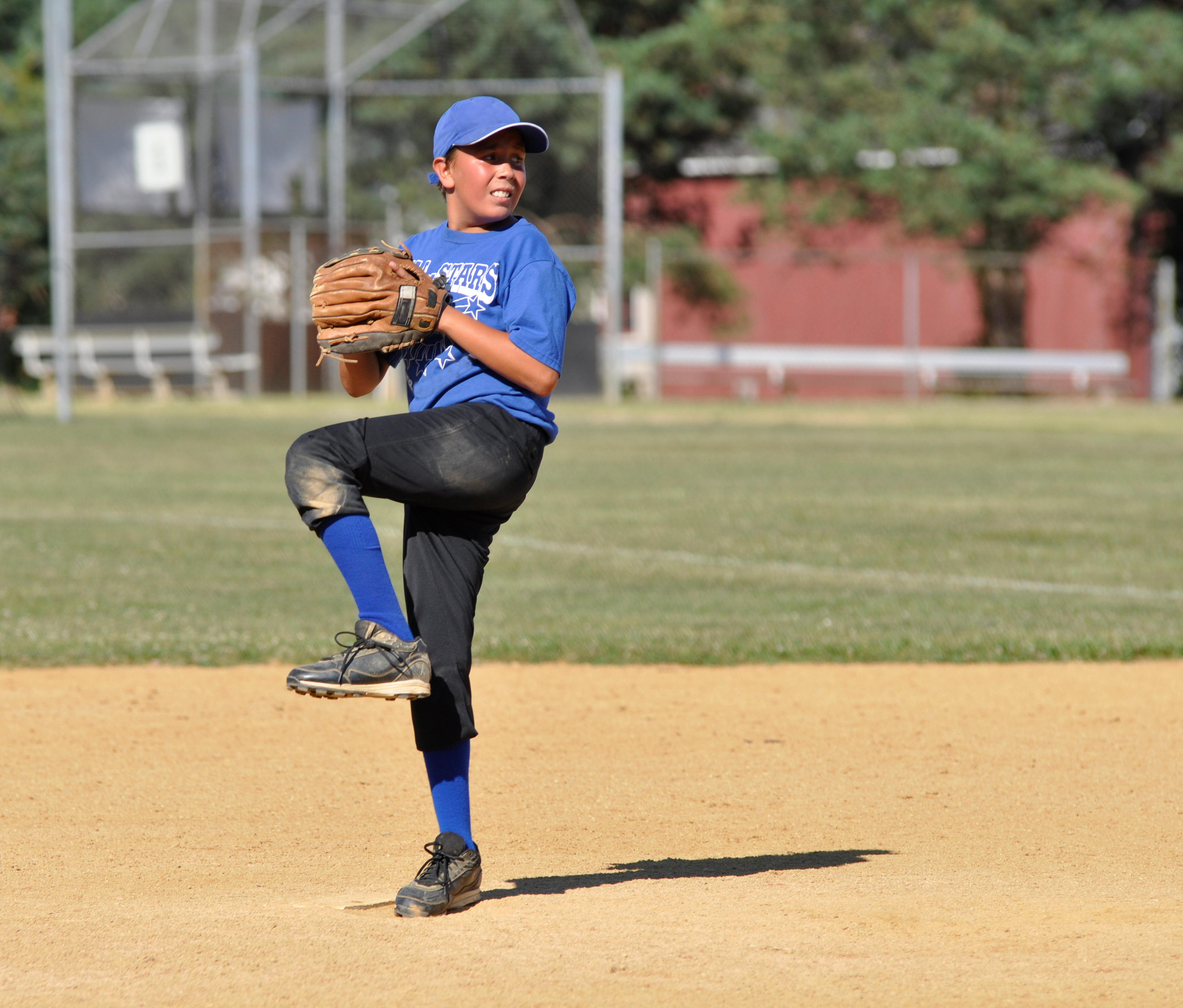 young baseball player throwing a pitch