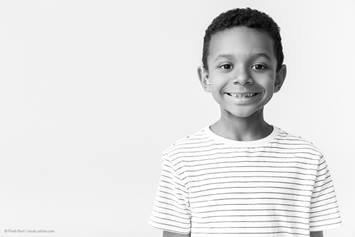 young boy in a striped shirt, smiling