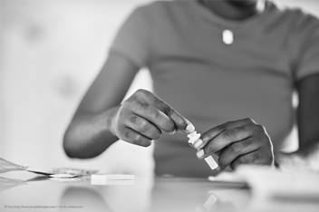 woman closing a test tube
