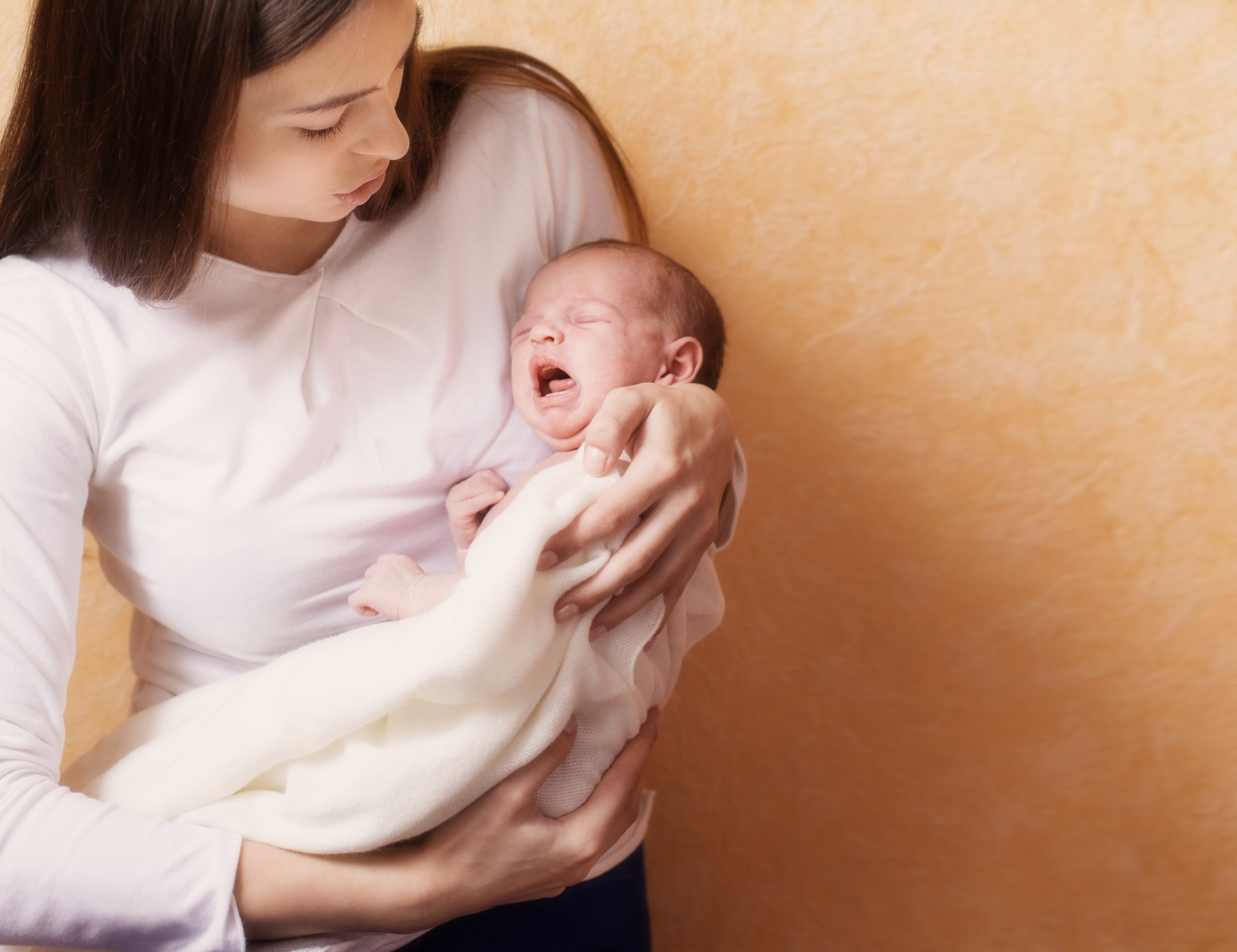 woman holding crying baby