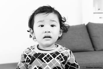 baby wearing a sweater looking like they might cry