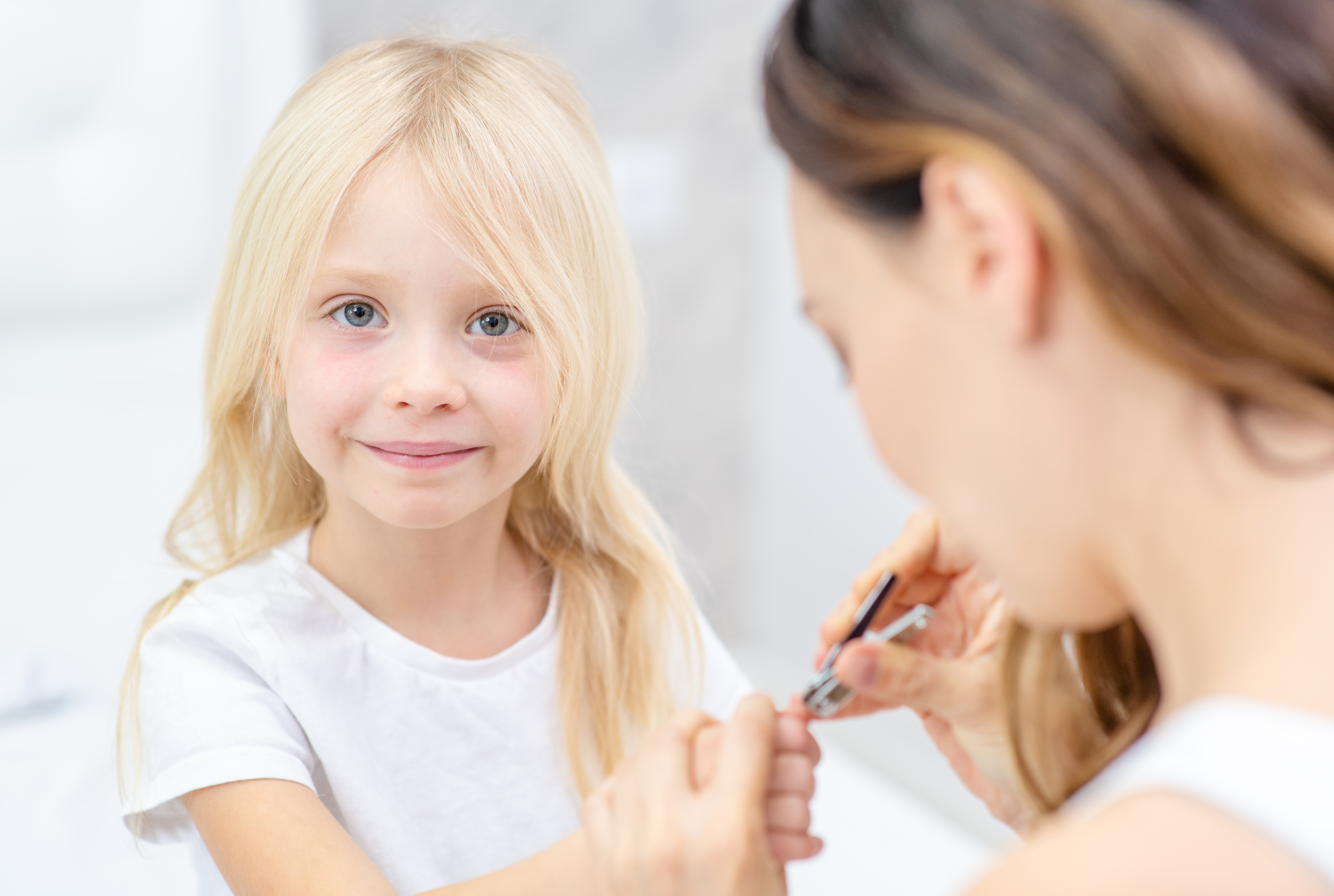 young girl getting her nails clipped