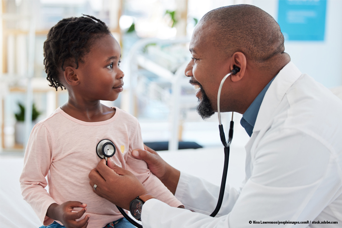 Toddler aged girl in an exam room with a doctor. 