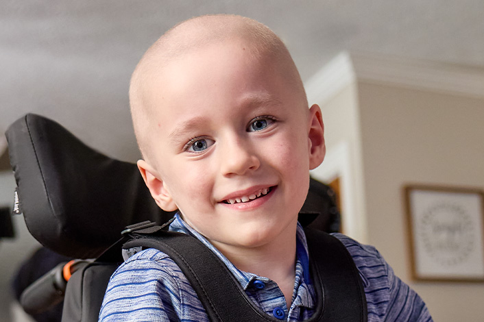 Young boy smiling at the camera.