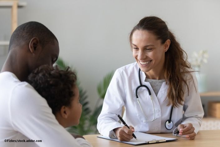 father and son talking to a Dr