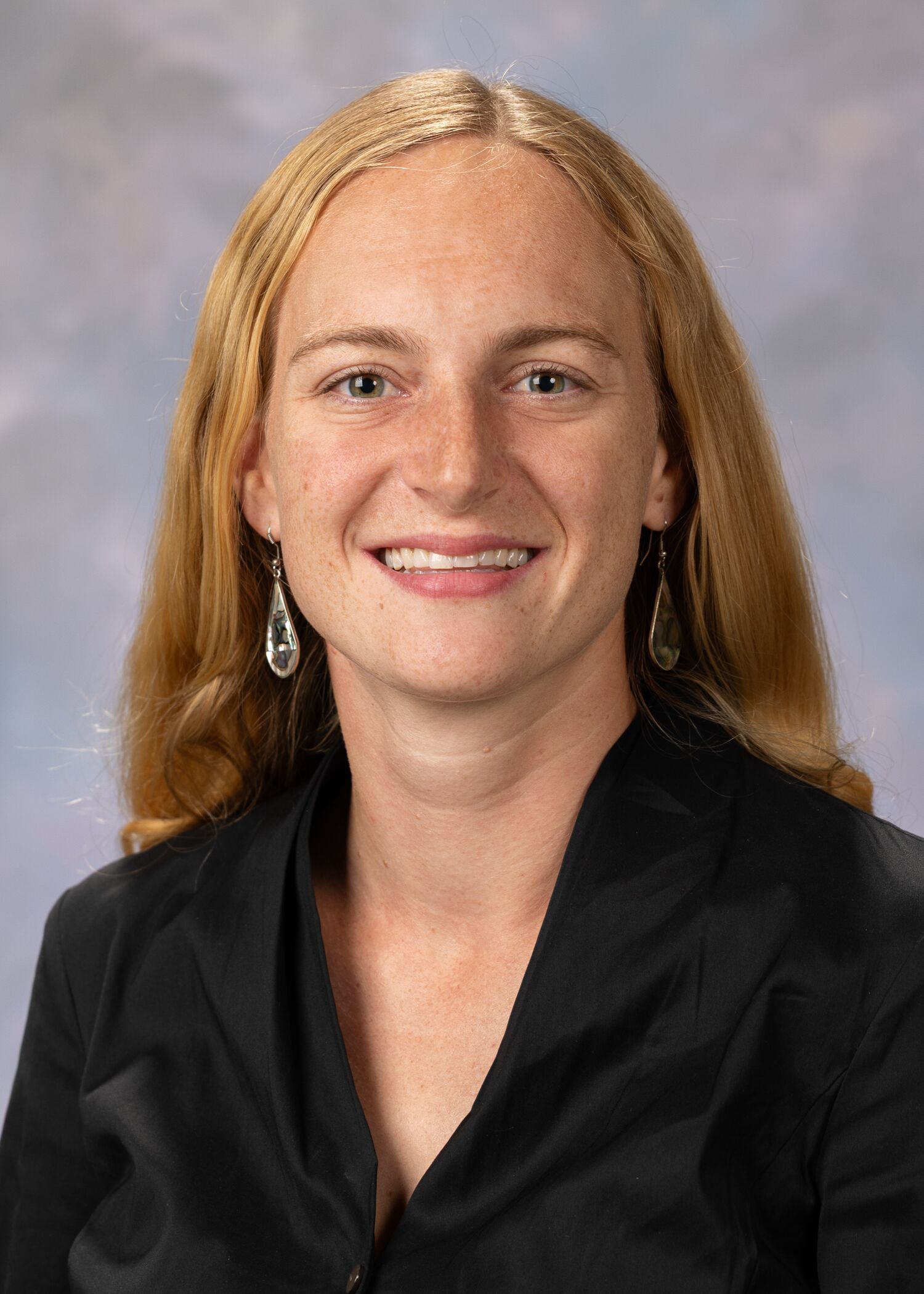 Portrait of Katherine Lehman, woman with long blonde hair and a black shirt.