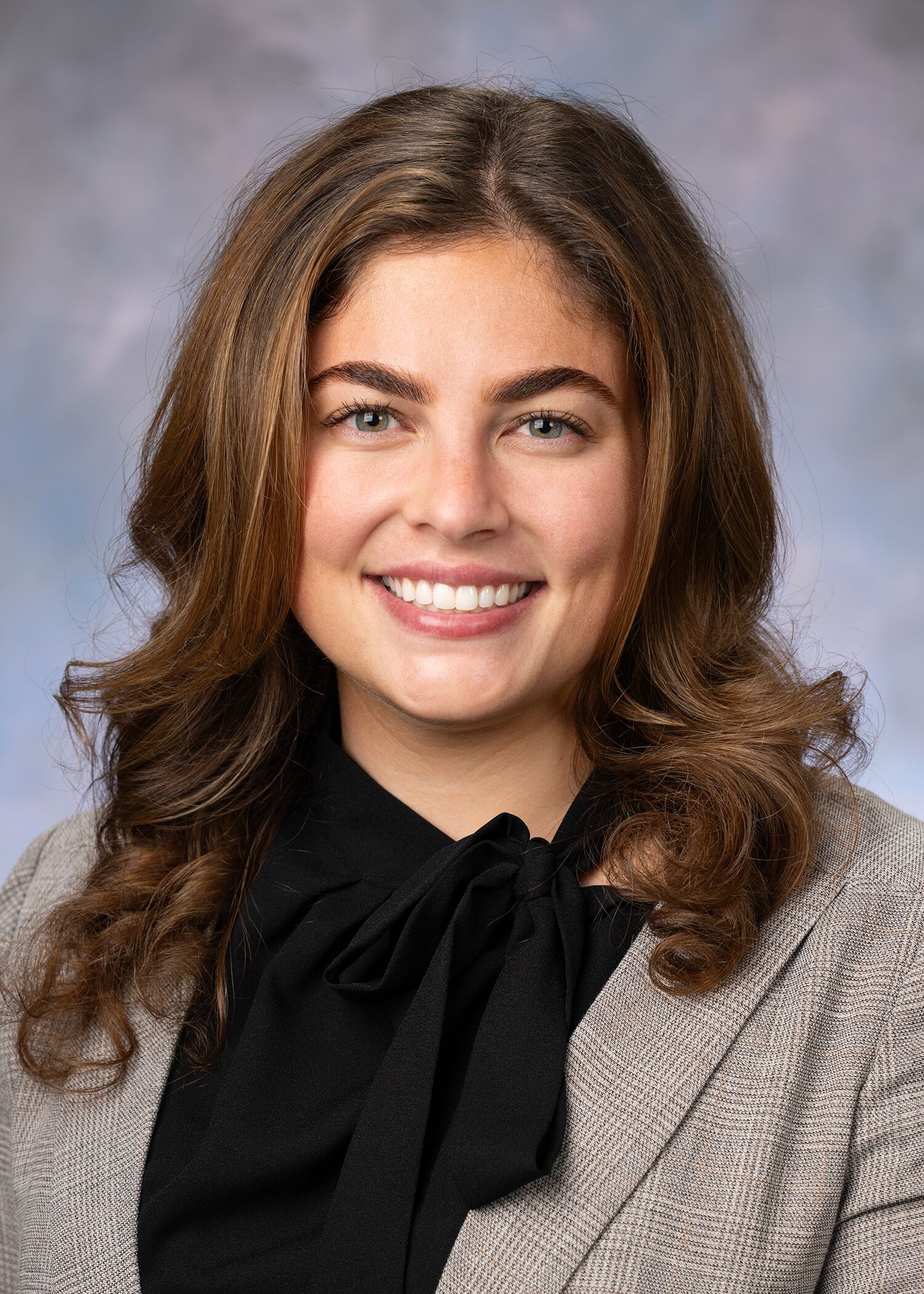 Portrait of Katherine Redden, woman with long brown hair and a black shirt.