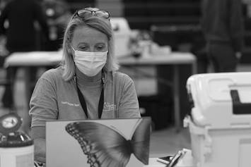 A Nationwide Children's employee works on a computer at a school-based vaccine clinic
