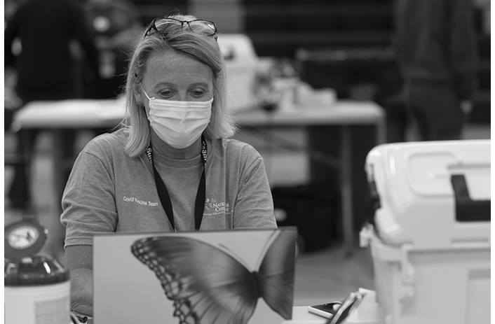 A Nationwide Children's employee works on a computer at a school-based vaccine clinic