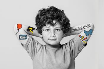 Elementary age boy with hands resting behind his head.