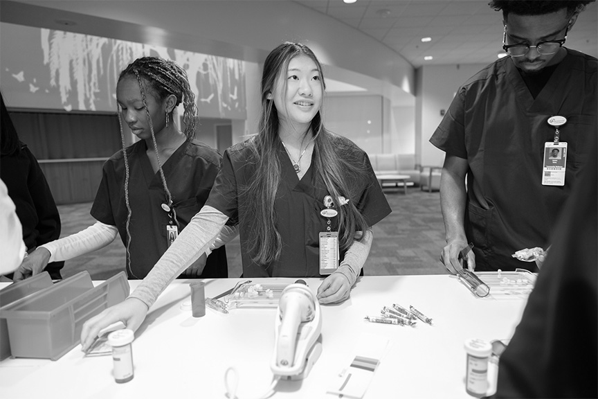 Three high school students in a clinical learning environment