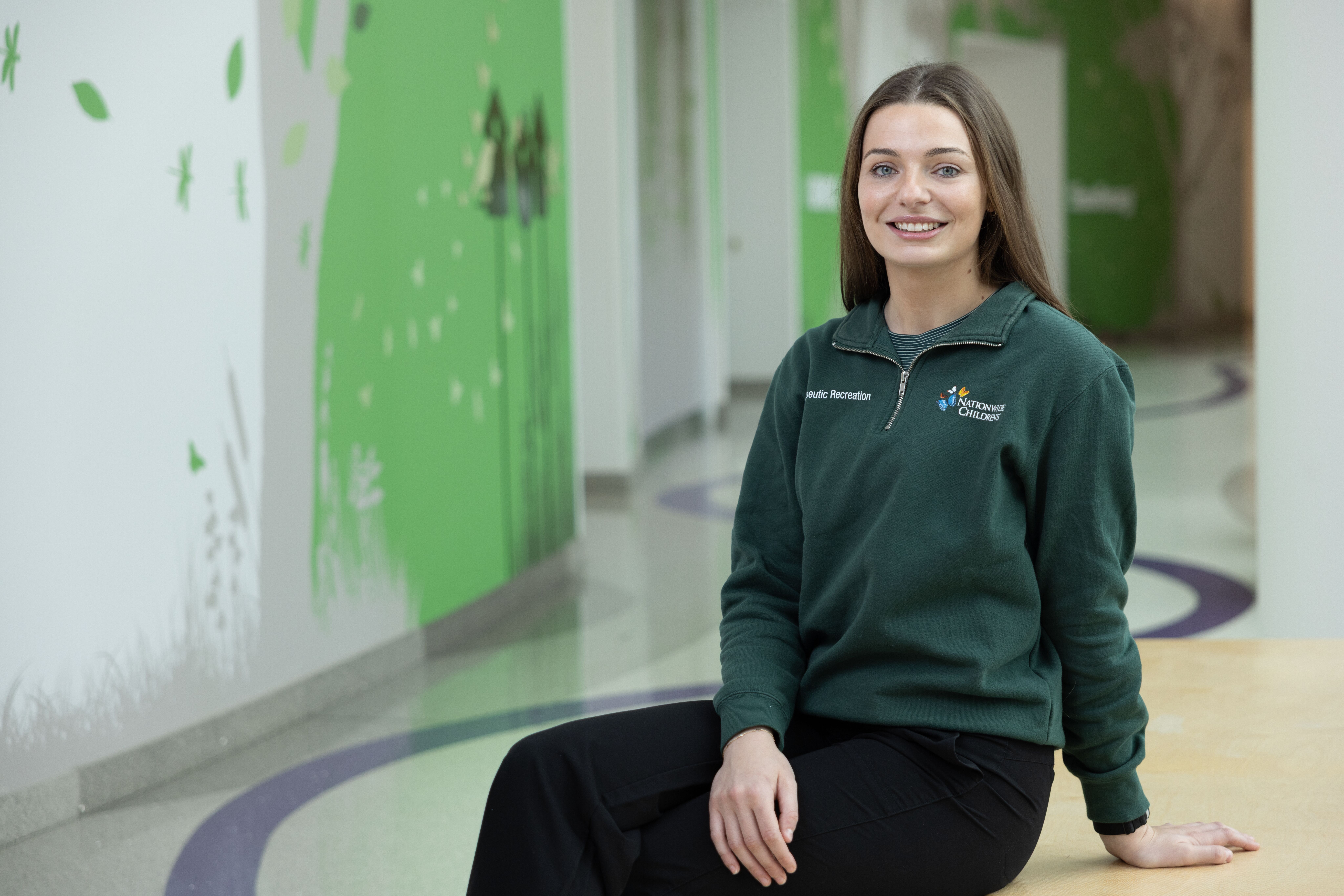 Nationwide children's employee sitting on bench in hallway
