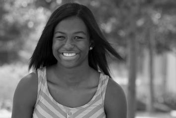 Teenage Girl Smiling and Sitting Outside