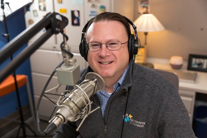Dr. Mike Patrick sitting in his PediaCast podcast studio.