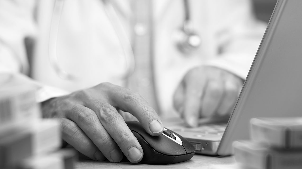 Provider's hand on a computer mouse