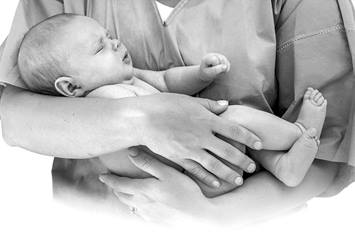 Medical professional holding newborn baby
