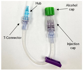 Photo showing the parts of a peripheral intravenous (PIV) catheter, including the hub, T-connector, alcohol cap, and injection cap.