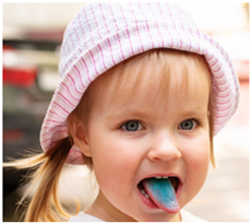 Picture of a child with their tongue sticking out with blue dye on their tongue