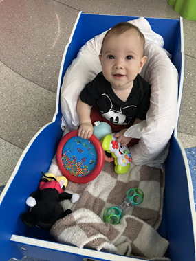 Lukas sitting in a hospital wagon