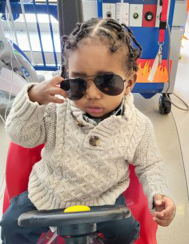 Shaun in a grocery cart wearing sunglasses
