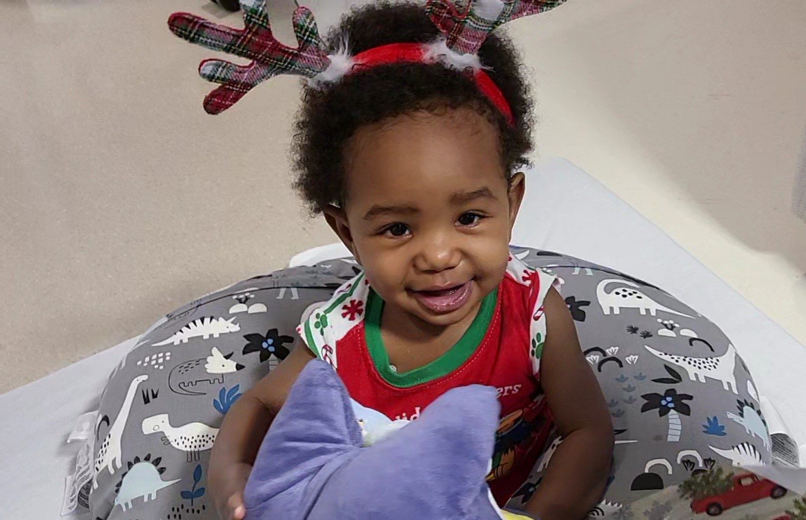Shaun smiling with reindeer antlers on