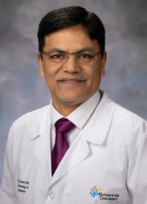 Portrait of Ahsan Syed, man with short black hair, glasses, and a white lab coat.