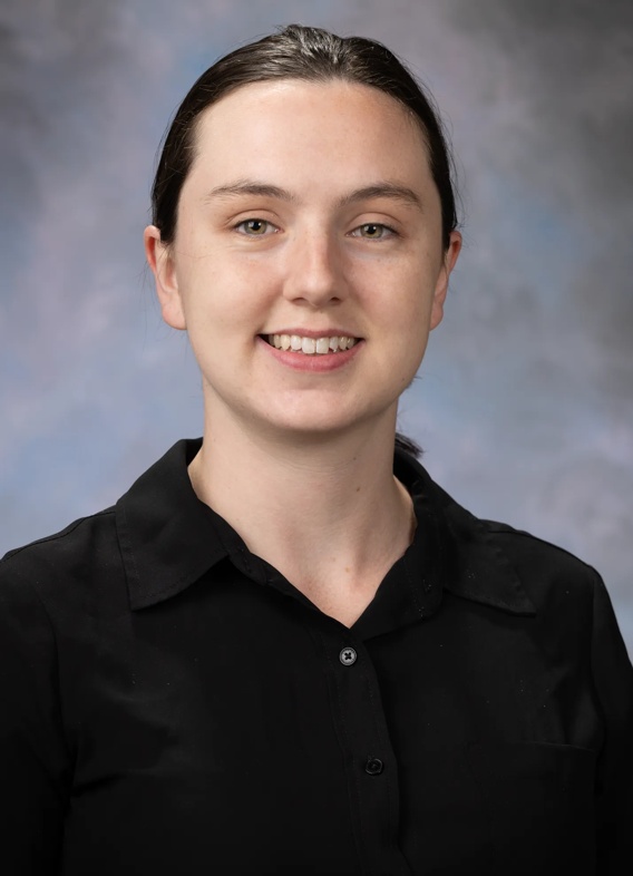 Portrait of Chiara Dart, woman with brown hair and a black shirt.