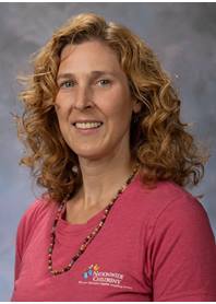 Portrait of Christine Havach. Christine is wearing a pink Nationwide Children's Hospital t-shirt.
