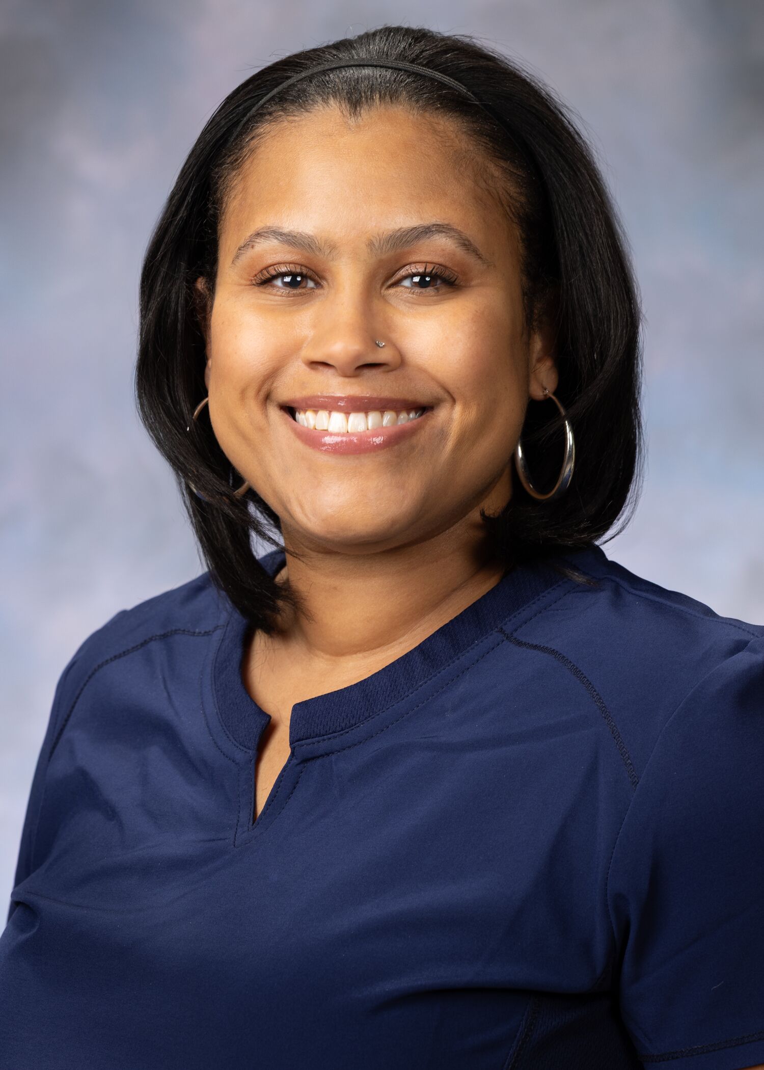 Portrait of Ebonee Emanuel, woman with short black hair and a blue blouse.
