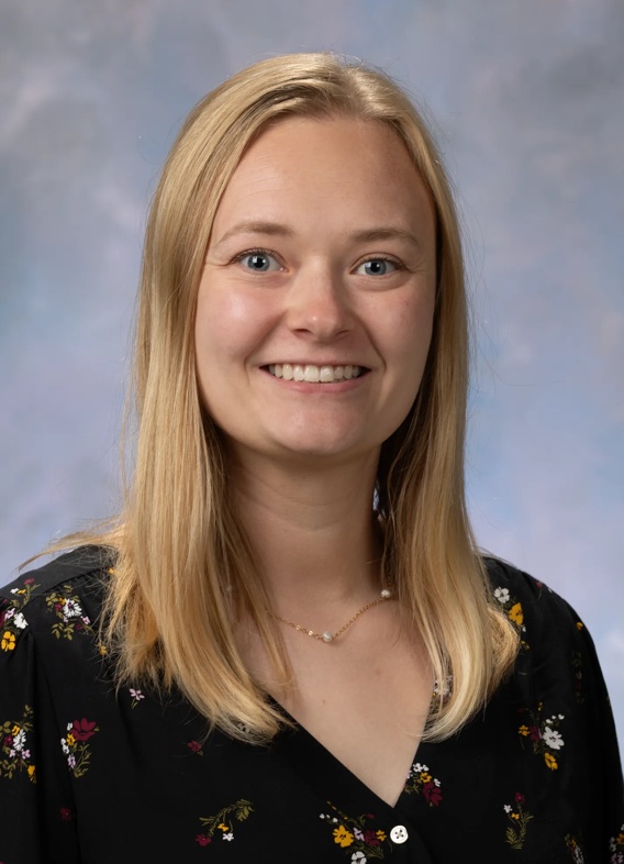 Portrait of Jenna Valentine, woman with long blonde hair and a black shirt.