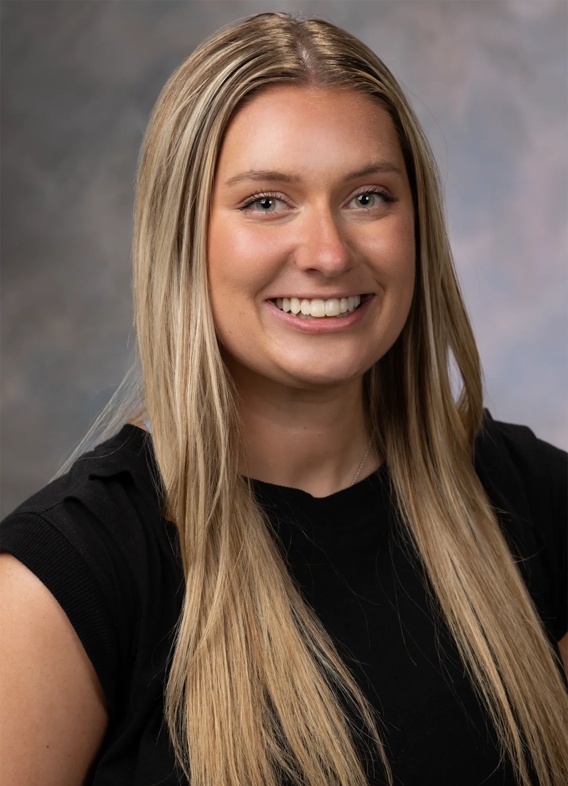 Portrait of Kayla Jennett, woman with long blonde hair and a black shirt.