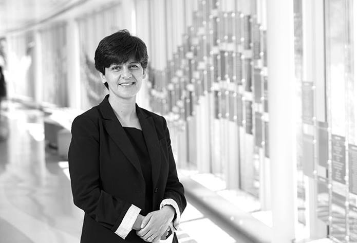 Marayam Fouladi, smiling, standing in a hallway at Nationwide Children's