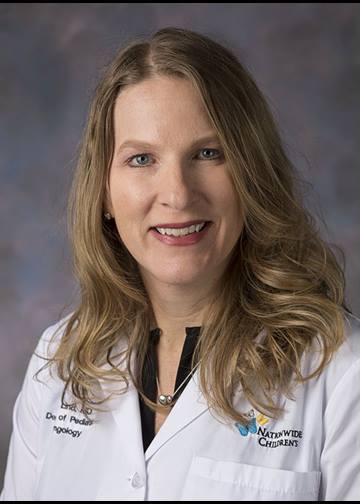 Portrait of Wisler Saint-Vil, MD, MBA. Wisler is wearing glasses and a blue suit with a white shirt. 