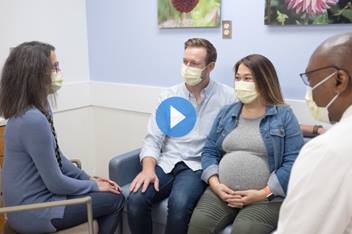 Pregnant woman and husband talking to CCPR team about cloacal exstrophy diagnosis.