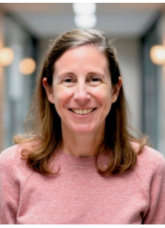 Portrait of Mary-Lynn Niland, MD. Mary-Lynn has shoulder length brown hair and is wearing a pink long-sleeve top. 