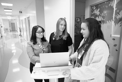 three fellows gathered around a computer