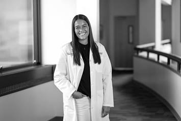 young woman doctor standing in the research building