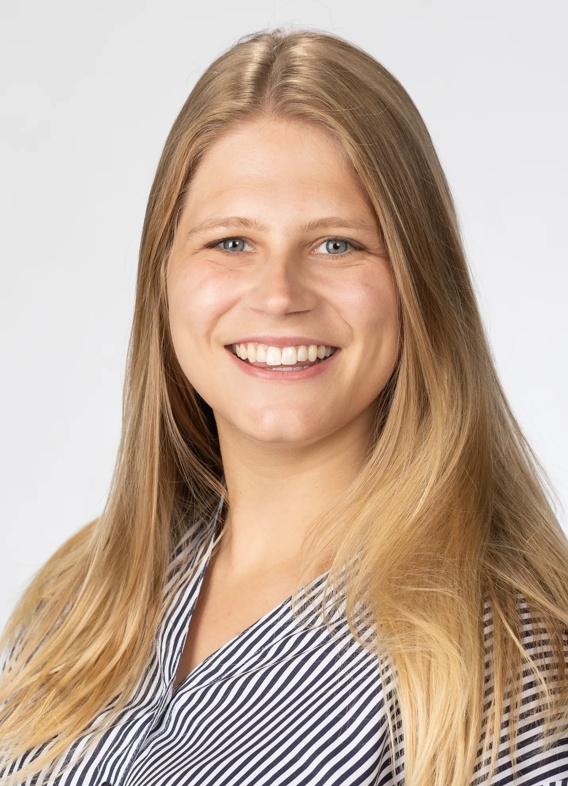 Portrait of Abigail Parro, woman with long blonde hair and a striped shirt.