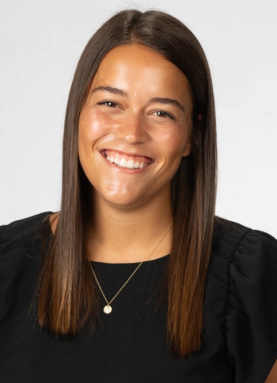 Portrait of Hannah Stephen, woman with long brown hair and a black shirt.