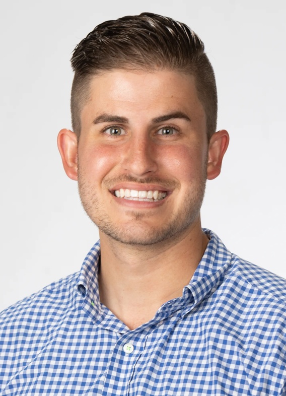 Portrait of Hunter Holsinger, man with short brown hair and a striped blue shirt.
