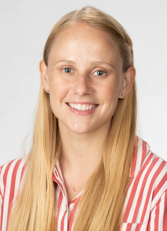 Portrait of Julia Halley, woman with long blonde hair and a striped red shirt.
