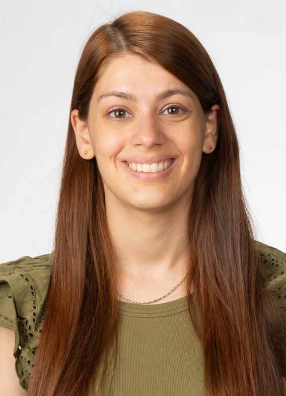 Portrait of Maria Fleiderman, woman with long brown hair and a green shirt.