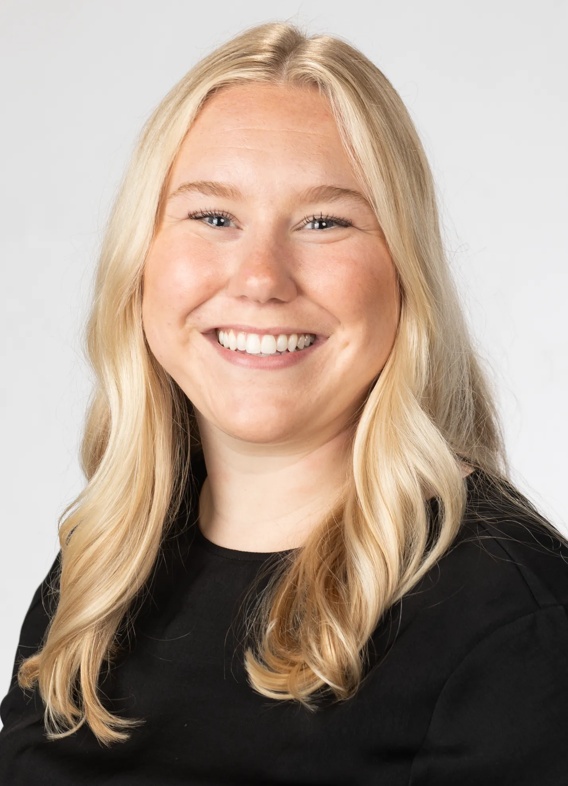 Portrait of Olivia Rice, woman with long blonde hair and a black shirt.