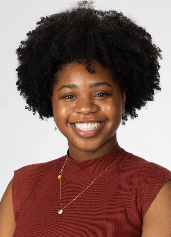 Portrait of Patrice Collins, woman with short black hair and a red shirt.