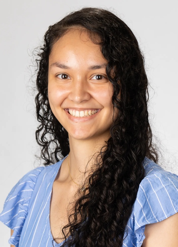 Portrait of Rachelle Wanser, woman with long black hair and a blue shirt.