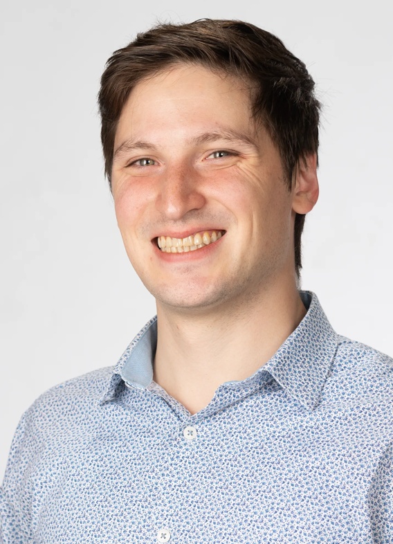 Portrait of Robert Burks, man with short brown hair and a grey shirt.
