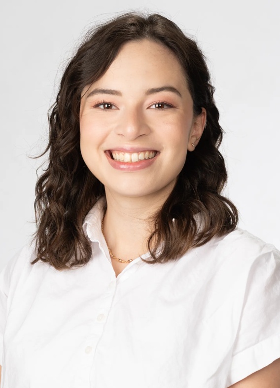 Portrait of Victoria Fahy, woman with short brown hair and a white shirt.