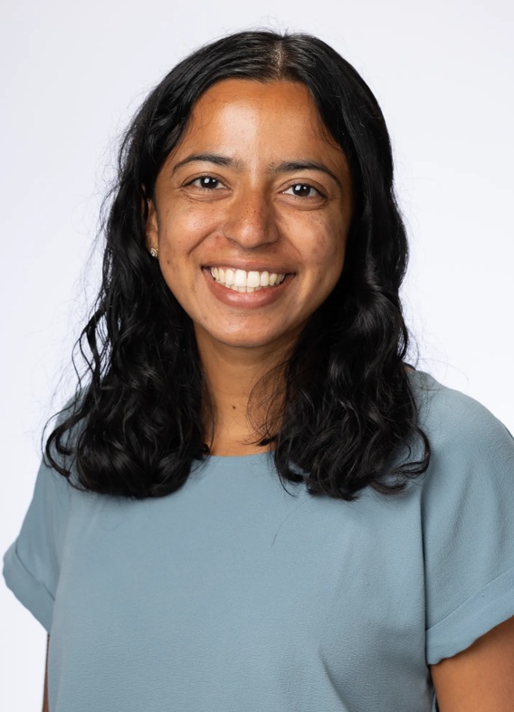 Portrait of Anamika Shah, woman with long black hair and a light blue shirt.