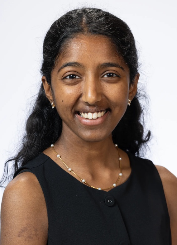 Portrait of Anthara Gnanakumar, woman with long black hair and a black shirt.