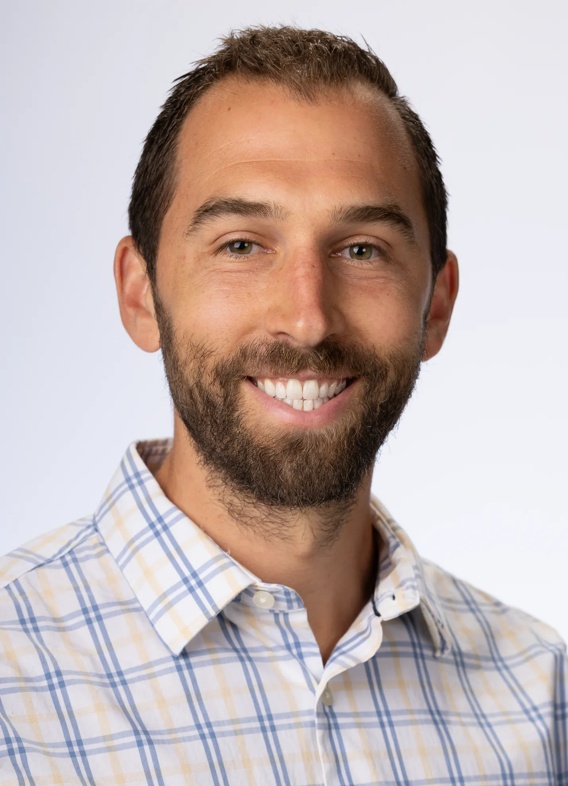 Portrait of Chad Barson, man with short brown hair and a striped shirt.